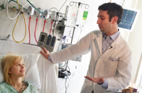 Dr. Levitt at a patient's bedside