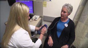 An ARNP sits with a Parkinson's patient